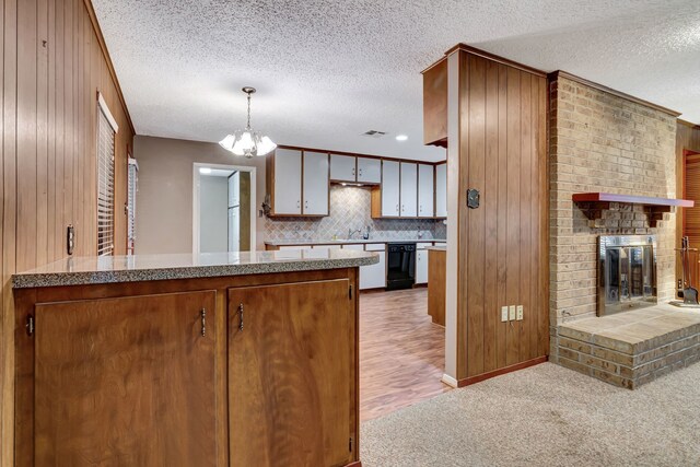 kitchen featuring black dishwasher, a textured ceiling, and a chandelier
