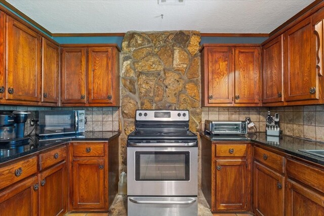 kitchen with stainless steel range with electric stovetop, tasteful backsplash, black microwave, a toaster, and a textured ceiling