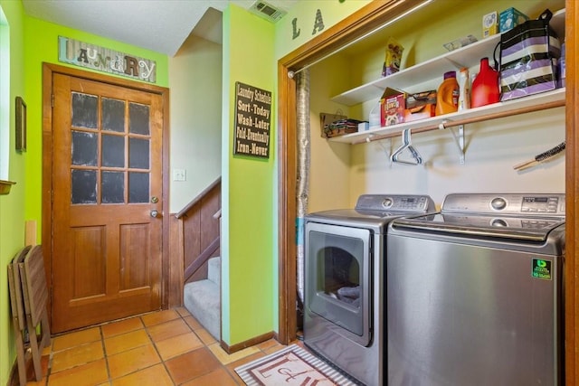 clothes washing area with laundry area, independent washer and dryer, wainscoting, light tile patterned floors, and visible vents