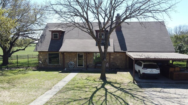 view of front of house featuring a chimney, fence, a carport, stone siding, and a front lawn