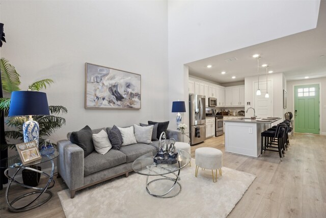 living area featuring recessed lighting and light wood-style flooring
