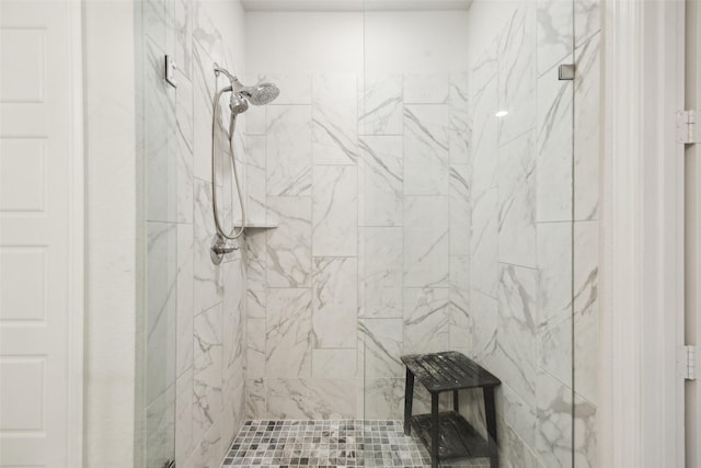 bathroom featuring a marble finish shower
