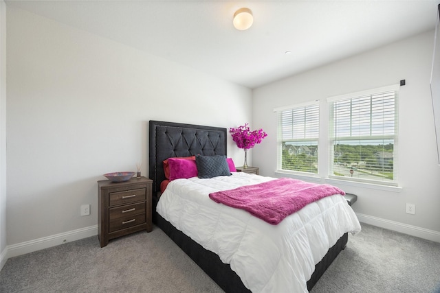 bedroom with light carpet and baseboards