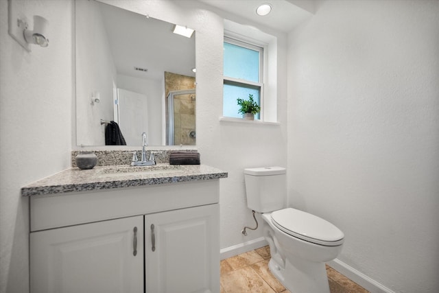 5816 Sandra Dr, Fort Worth, TX 76133 - bathroom featuring vanity, visible vents, toilet, baseboards, and a shower stall