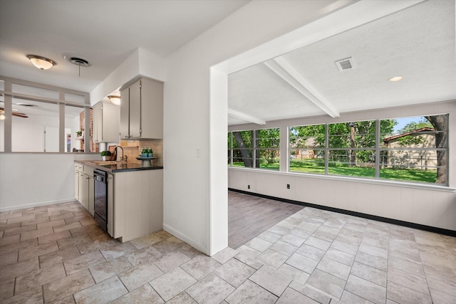 5816 Sandra Dr, Fort Worth, TX 76133 - kitchen with dark countertops, a sink, beam ceiling, dishwasher, and baseboards