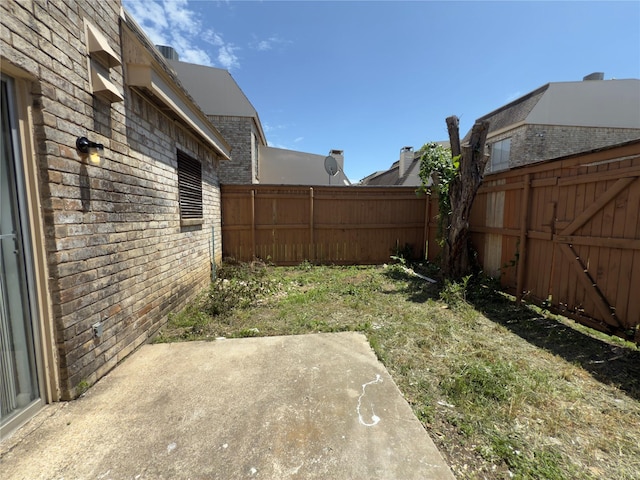 view of yard featuring a fenced backyard and a patio area