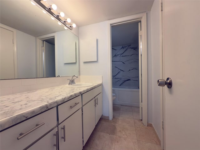 bathroom featuring toilet, vanity, and  shower combination