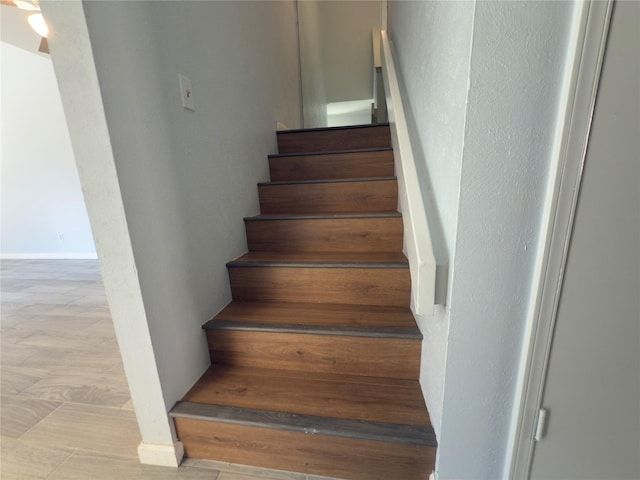 stairway featuring baseboards