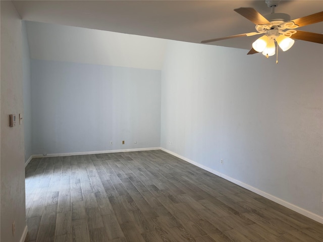 empty room with baseboards, a ceiling fan, and dark wood-style flooring