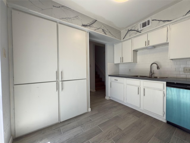 145 Trellis Pl, Richardson, TX 75081 - kitchen featuring dishwasher, a sink, wood finish floors, white cabinets, and decorative backsplash