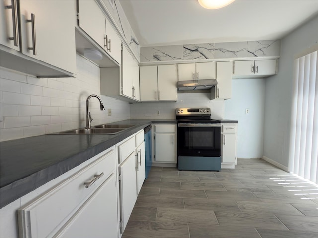 kitchen featuring stainless steel range with electric cooktop, under cabinet range hood, backsplash, dark countertops, and a sink