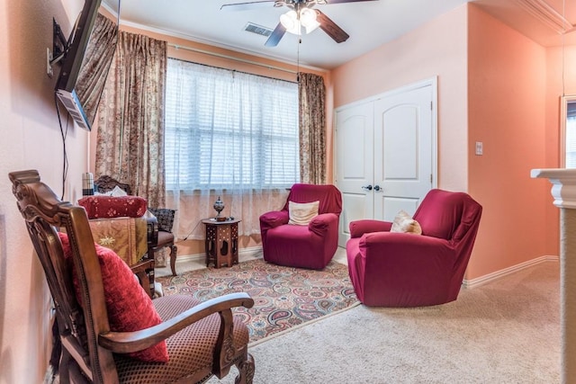 sitting room with baseboards, a ceiling fan, and carpet floors