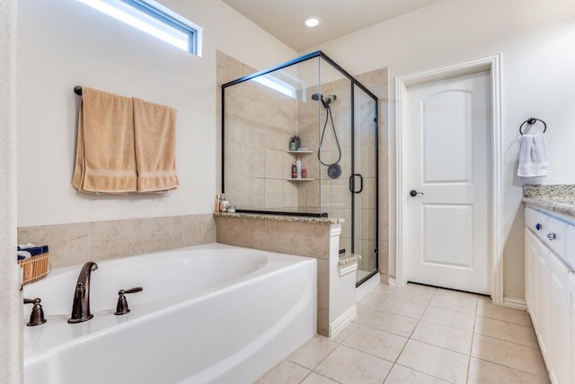 bathroom featuring a bath, tile patterned flooring, vanity, and a stall shower