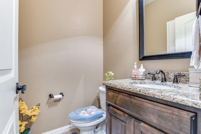 bathroom with toilet and vanity