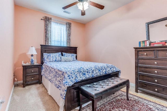 bedroom with light colored carpet, visible vents, a ceiling fan, and baseboards