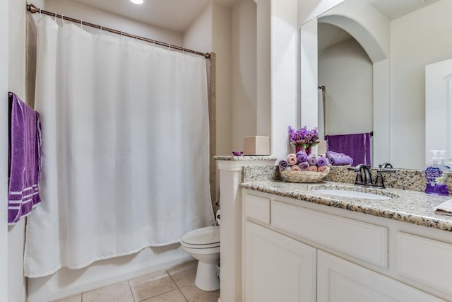 bathroom with tile patterned floors, shower / tub combo, toilet, and vanity