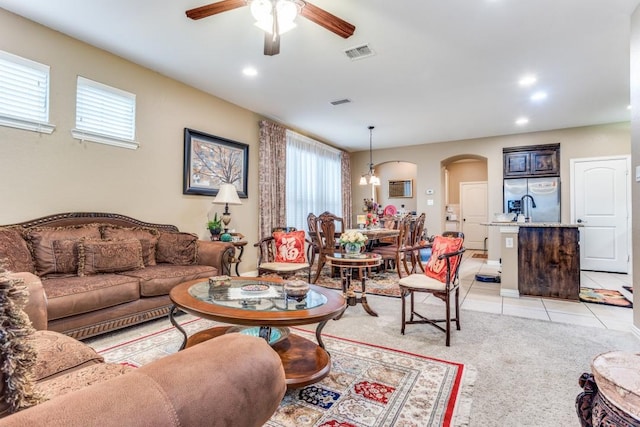 living area with visible vents, arched walkways, light tile patterned flooring, recessed lighting, and a ceiling fan