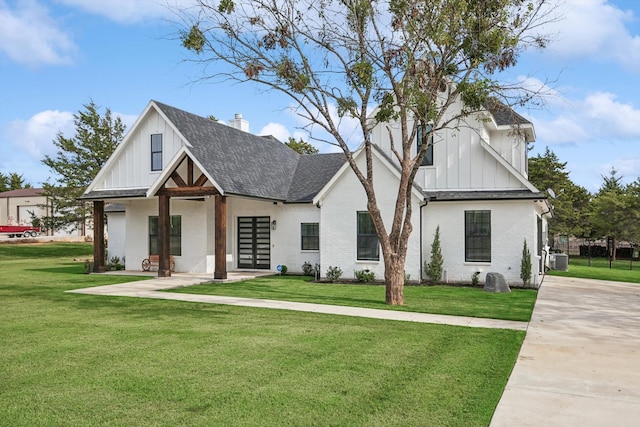 328 Brandon Way, Pottsboro, TX 75076 - modern farmhouse with board and batten siding, roof with shingles, a front yard, and brick siding