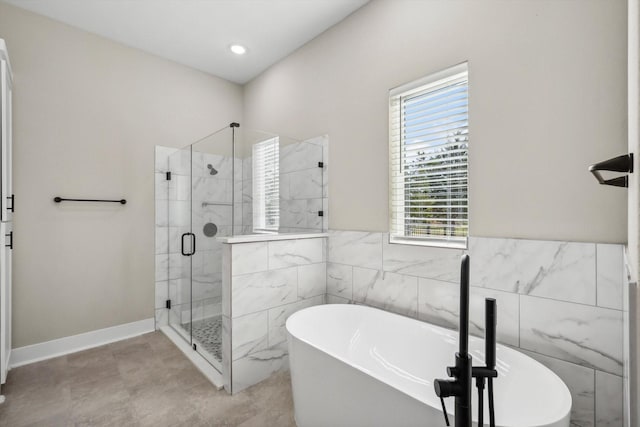 328 Brandon Way, Pottsboro, TX 75076 - full bathroom with healthy amount of natural light, a shower stall, a freestanding tub, and tile walls