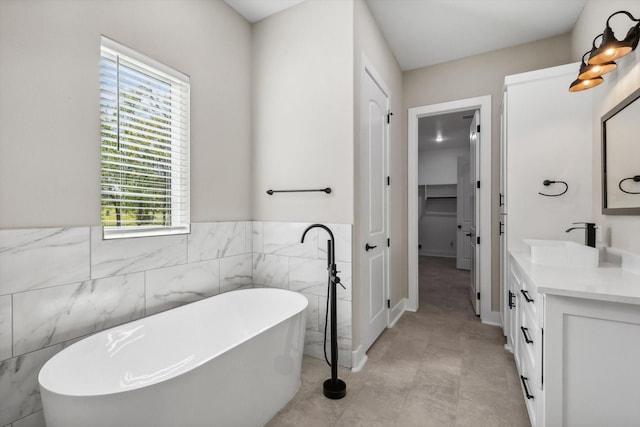 328 Brandon Way, Pottsboro, TX 75076 - bathroom with vanity, tile walls, a freestanding bath, and wainscoting