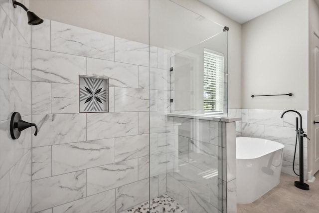 328 Brandon Way, Pottsboro, TX 75076 - bathroom featuring tiled shower, a freestanding tub, and tile walls