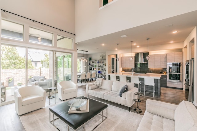 3901 Campania Ct, Colleyville, TX 76034 - kitchen with wall chimney range hood, a sink, stainless steel appliances, modern cabinets, and backsplash