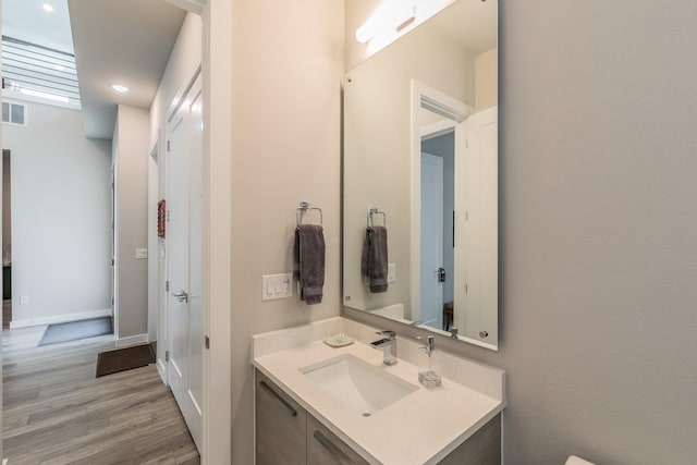 3901 Campania Ct, Colleyville, TX 76034 - bathroom with recessed lighting, vanity, visible vents, baseboards, and wood finished floors