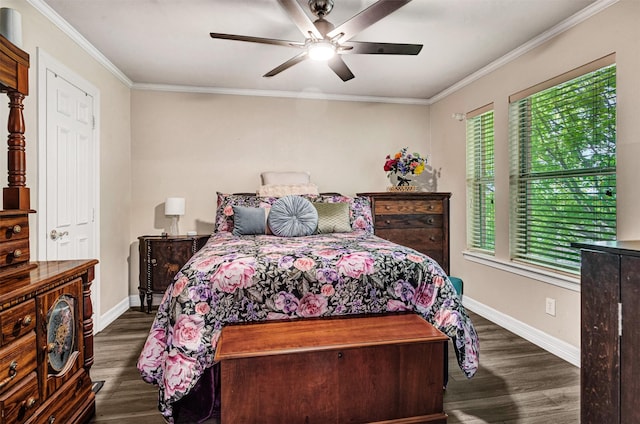 bedroom featuring crown molding, dark wood-style flooring, and baseboards