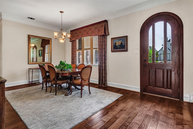 dining area featuring crown molding, baseboards, visible vents, and an inviting chandelier