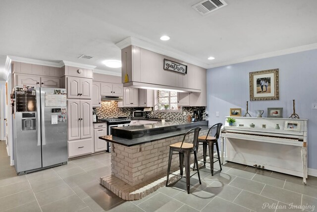 448 Kennie Rd, Shreveport, LA 71106 - kitchen with appliances with stainless steel finishes, visible vents, under cabinet range hood, ornamental molding, and a peninsula