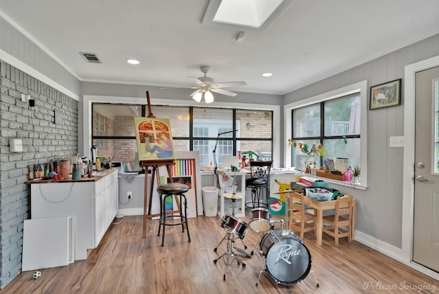 448 Kennie Rd, Shreveport, LA 71106 - dining area with brick wall, visible vents, baseboards, a skylight, and wood finished floors