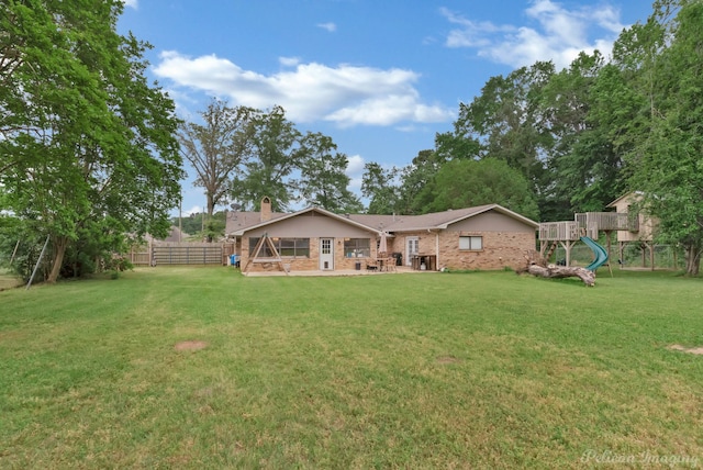448 Kennie Rd, Shreveport, LA 71106 - back of house featuring fence, a chimney, a lawn, and a playground