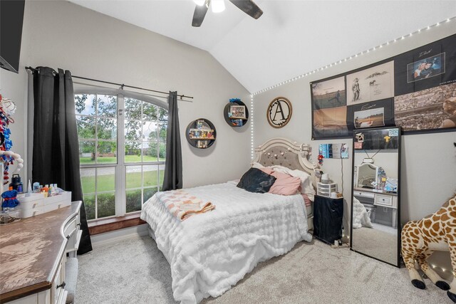 bedroom with lofted ceiling, a ceiling fan, and carpet floors