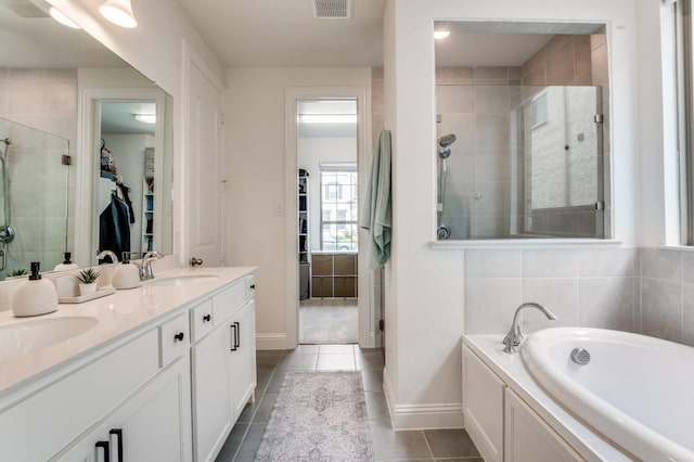 full bathroom featuring a shower stall, a sink, visible vents, a bath, and tile patterned flooring