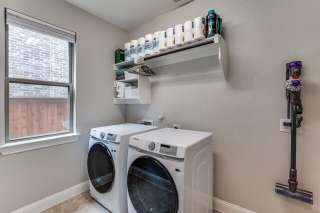 laundry room with washing machine and clothes dryer, laundry area, and baseboards