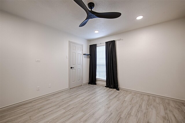 empty room with light wood-style floors, a ceiling fan, recessed lighting, and baseboards