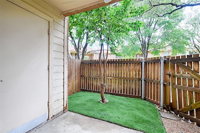 view of patio featuring fence and a gate