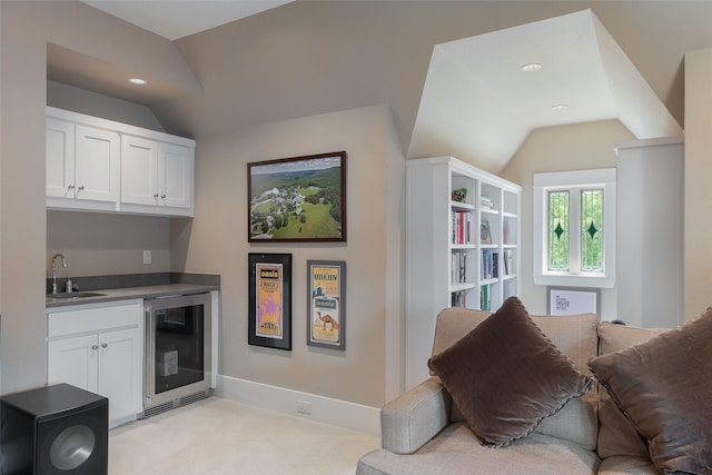 5313 Ridgedale Ave, Dallas, TX 75206 - living area featuring beverage cooler, vaulted ceiling, bar with sink, recessed lighting, and light colored carpet