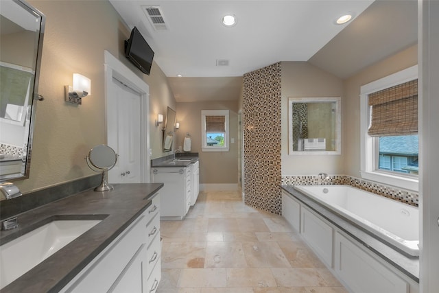 5313 Ridgedale Ave, Dallas, TX 75206 - bathroom featuring two vanities, a bath, recessed lighting, a walk in shower, and lofted ceiling