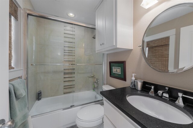 5313 Ridgedale Ave, Dallas, TX 75206 - bathroom with vanity, bath / shower combo with glass door, toilet, and recessed lighting