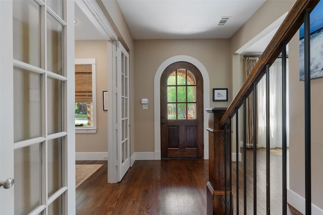 5313 Ridgedale Ave, Dallas, TX 75206 - entryway featuring arched walkways, dark wood-style floors, baseboards, french doors, and stairs