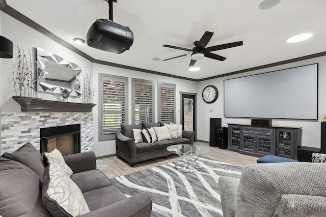 cinema room featuring baseboards, ornamental molding, ceiling fan, and wood finished floors