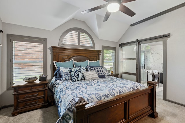 bedroom featuring ceiling fan, vaulted ceiling, a barn door, baseboards, and light carpet