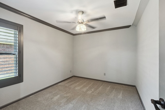 unfurnished room featuring ceiling fan, visible vents, baseboards, ornamental molding, and carpet