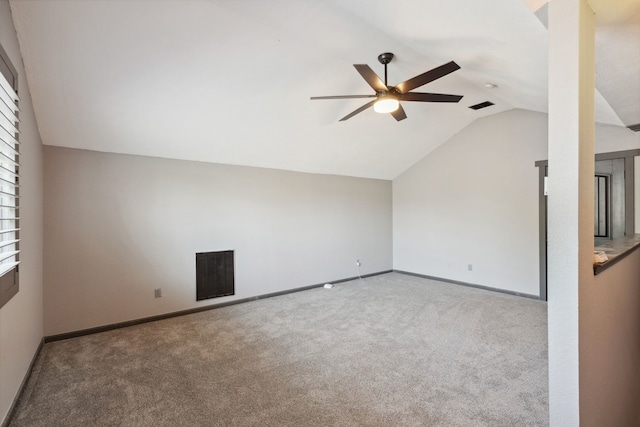 unfurnished room featuring ceiling fan, visible vents, carpet floors, baseboards, and vaulted ceiling