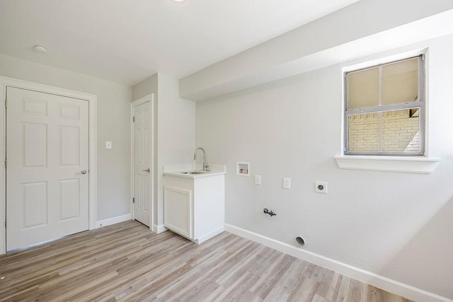 laundry room featuring hookup for a washing machine, hookup for an electric dryer, gas dryer hookup, a sink, and light wood-type flooring