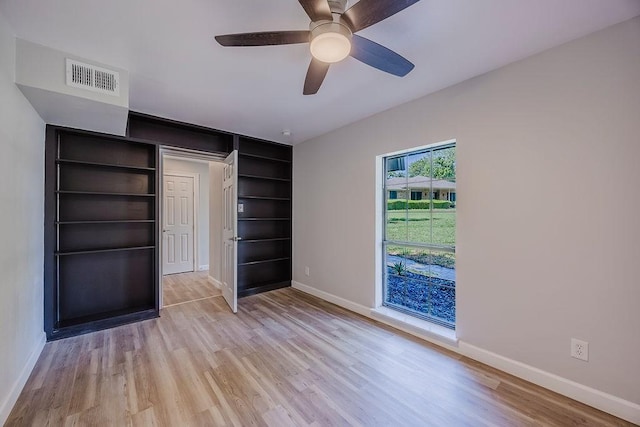 unfurnished bedroom with visible vents, ceiling fan, light wood finished floors, and baseboards
