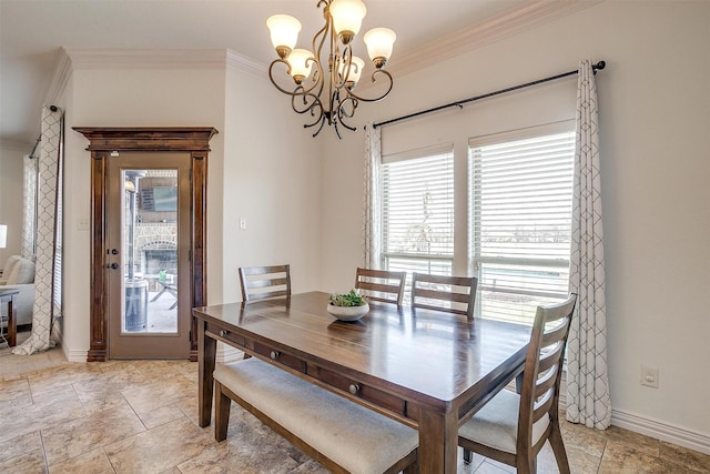 dining space featuring ornamental molding, stone finish flooring, a chandelier, and baseboards