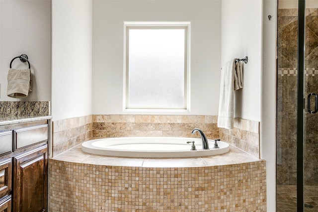 full bath with a stall shower and a bath