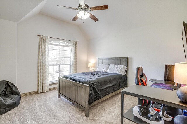 bedroom featuring lofted ceiling, ceiling fan, baseboards, and light carpet